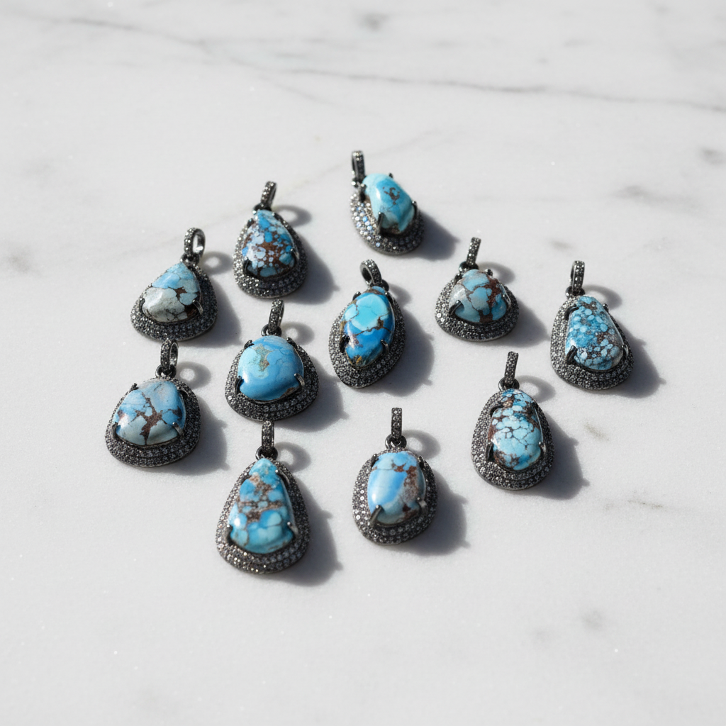 Turquoise and pavé diamond pendants editorial flat lay on white marble